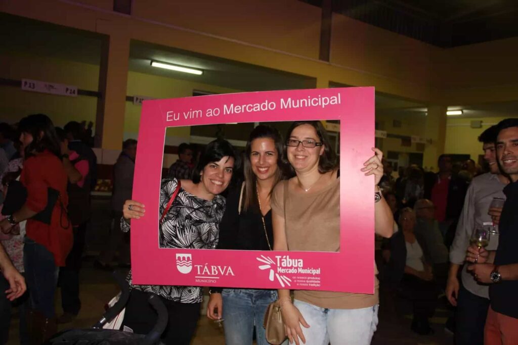 Três participantes posam na moldura Eu vim ao Mercado Municipal